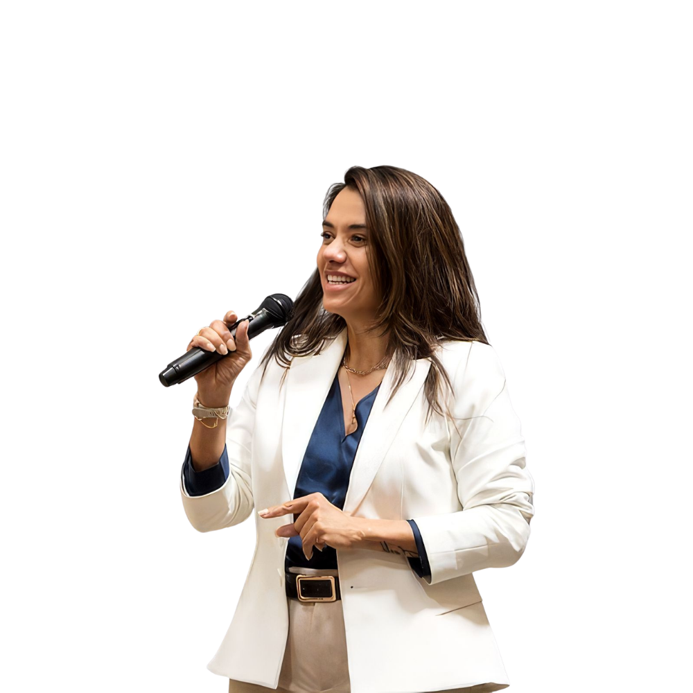 Christiane Drew speaking on stage with a microphone